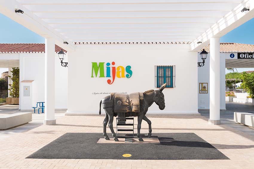 MIJAS PUEBLO, SPAIN - 11 June 2022: Donkey statue in front of tourist office in Mijas, Andalucia. The town is famous for donkey carriages and white buildings